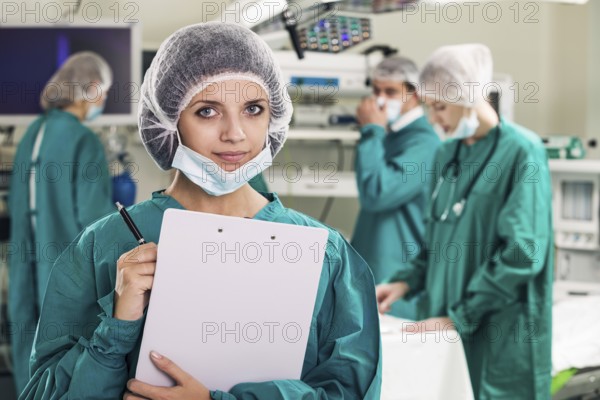 Portrait of surgeons in surgery with doctors working on background