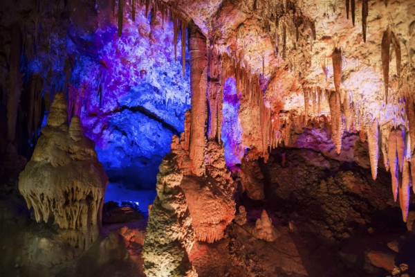 Venetsa Cave in Bulgaria. Beautiful colorful and illuminated cave full with semiprecious onyx stones. Flowstones, stalactites and stalagmites lighted in different vivid colours