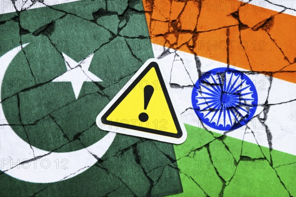 Danger sign with exclamation mark on the flags of Pakistan and India, symbolic photo Kashmir conflict, photomontage