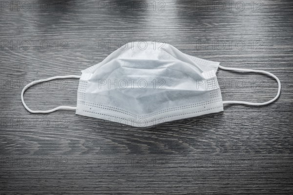 Sterile flu mask on vintage wooden board
