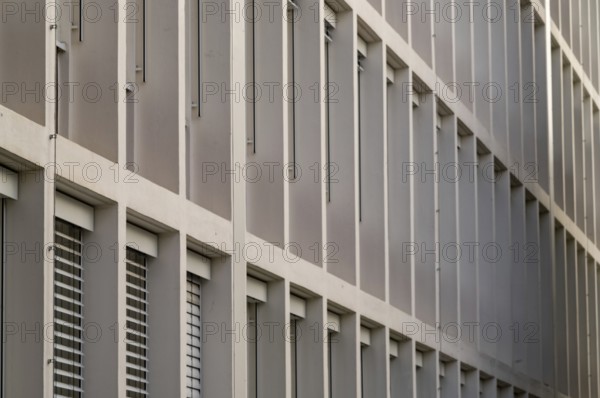 Long rows of windows of an office building from the 1960s