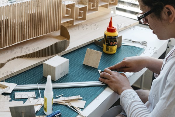 Woman architecture student working on models. Close up