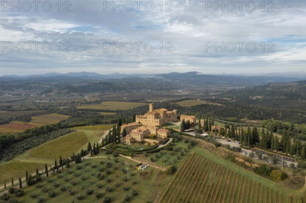 Montalcino, Italy, 16 November, 2023: aerial view of the Poggio alle Mura Castle and Villa Banfi wine resort in Tuscany, Europe