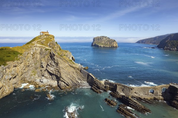 The most extraordinary coast of Spain. The island Gastelugache connected to the mainland by a bridge and winding staircase. Photo taken from a drone. Basque Country. Magical landscape