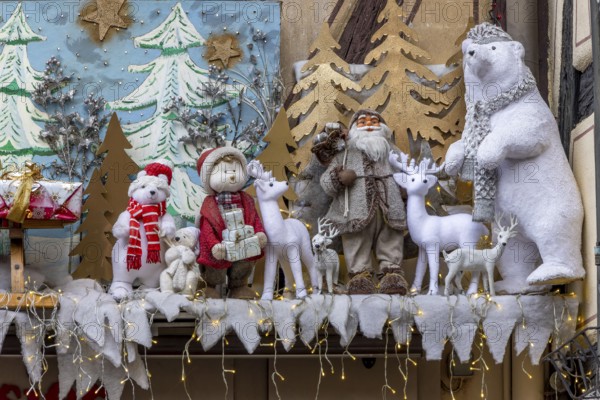 Brown half-timbered building decorated for Christmas with Father Christmas, Tedi bear and deer under the window on Pl. Jeanne d'Arc, Colmar, Alsace, Département Bas-Rhin, France, Europe