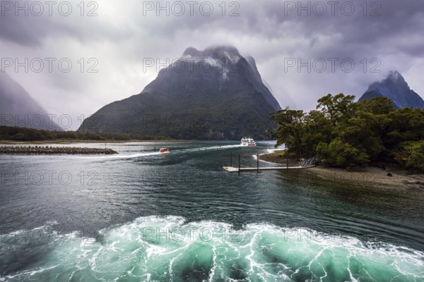 New Zealand - land of goblins and hobbits. Cold wind from Antarctica ruffles the water of the Milford Sound fjord. Concept of exotic, active and photographic tourism