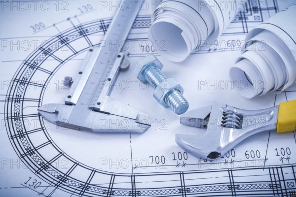 Stainless bolt with nut adjustable spanner trammel caliper construction drawings on blueprint architecture and building concept