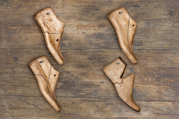 Shoe lasts hanging on a wooden wall