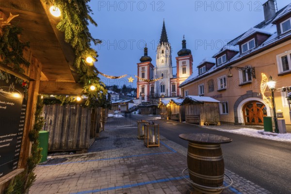 Advent atmosphere, street illuminated for Christmas, facade of the basilica behind, blue hour in the early morning, Mariazell, Styria, Austria, Europe