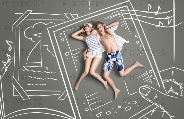Happy valentines love story concept of a picture of a romantic couple, sharing headphones and listening to the music against chalk drawings background of a photo book