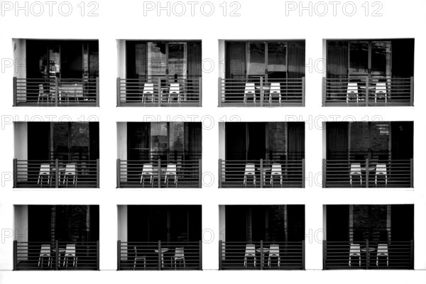 The exterior façade of a modern hotel with recessed balconies