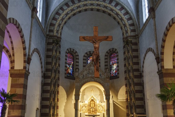 Romanesque church interior with wooden cross, colourful windows and pastoral atmosphere, ankum, Lower Saxony, Germany, Europe