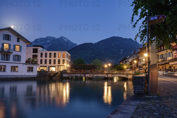 Serene village view at night with a bridge and river reflections, city, vilage, cityscapes, streets, old architecture, old buildings, Interlaken, Switzerland, Europe