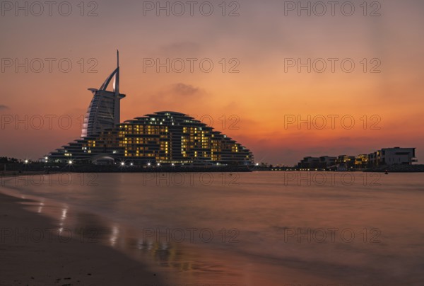 A picture of the Jumeirah Public Beach, the Jumeirah Marsa Al Arab Hotel and the Burj Al Arab Hotel, at sunset