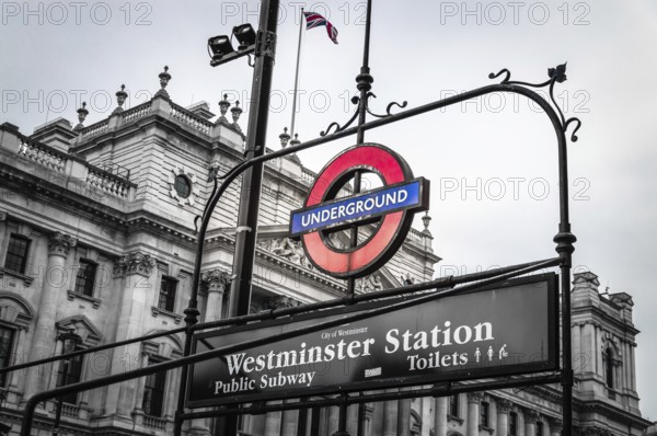 London, UK, August 18, 2015: London underground sign of Westminster station. The London Underground logo is one of the most recognised British icons. Black and white image with color sign