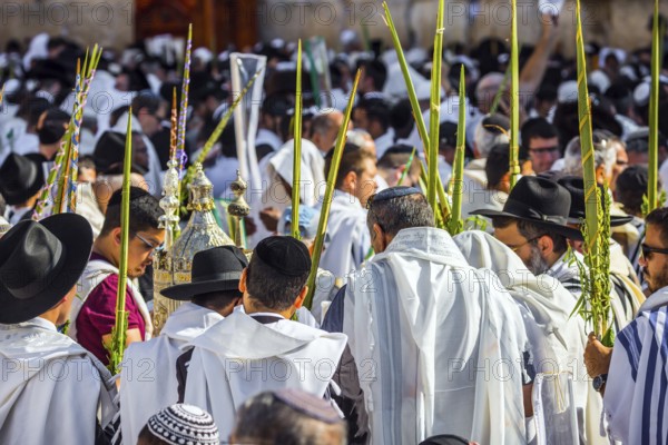 Jerusalem, Israel. Jews praying at the Western Wall wrapped in white Talit. Blessing of the Cohenim in Passover. Solemn celebratory ceremony at the Western slope of the Temple Mount. The concept of pilgrimage
