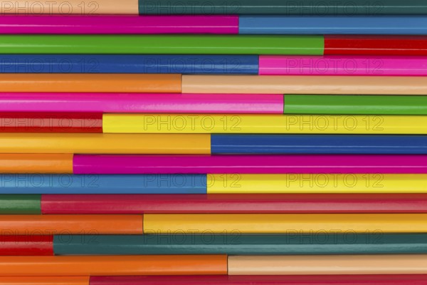 Collection of coloured pencils in a horizontal line pattern as background picture