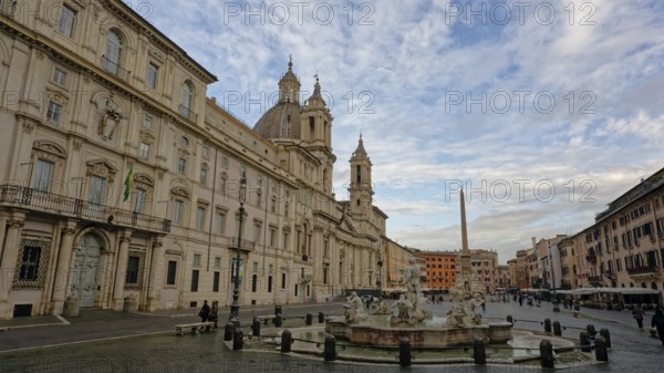 Piazza Navona with its striking church and obelisk under a partly cloudy sky, Rome, Lazio, Italy, Europe