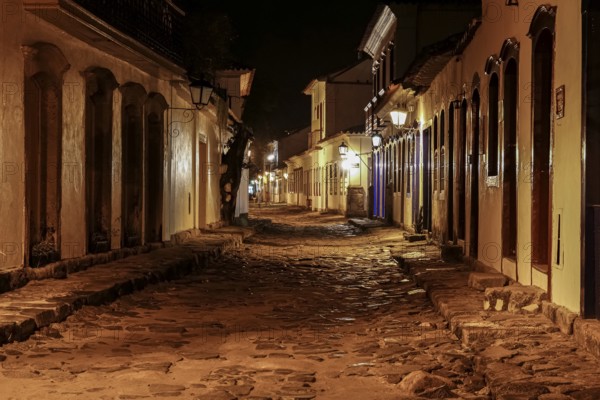 Atmospheric night view of illuminated street and buildings in historical center of Paraty, Brazil, Unesco World Heritage, South America