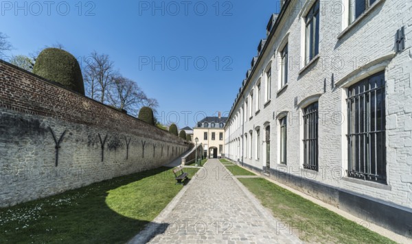 Ixelles, Brussels, Belgium, 03 30 2019: Panoramic ultra wide view over the park and site of the La Cambre Abbey during a sunny spring day, Europe