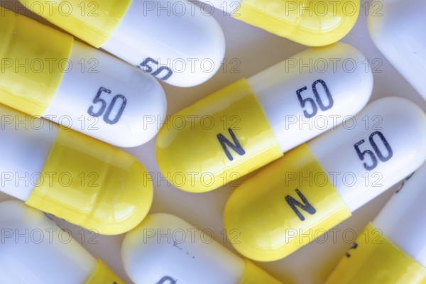 A macro close up to white and yellow N 50 capsules