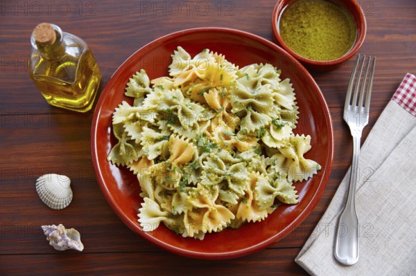 Farfalle pasta with Pesto on wooden table