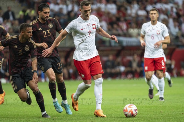 WARSAW, POLAND - JUNE 16, 2023: Friendly football match Poland vs Germany 1:0. In action Thilo Kehrer (5) Emre Can (23) Arkadiusz Milik (7).