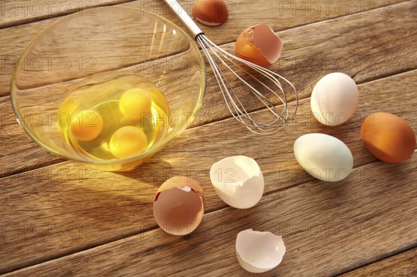 Eggs and shaker on wood with blue easter white and brown egg colors