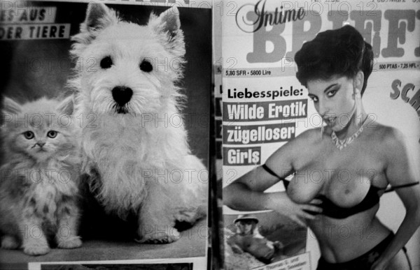 Germany, Berlin, 14/02/1992, Magazine kiosk in the underground station (Leopoldplatz), dog, cat and woman ... (Wild eroticism, licentious girls), Europe