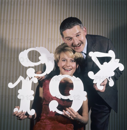 Fun with numbers in the 1960s. A woman and a man are holding different numbers in their hands 1, 4, 6 and 9. Unclear what the purpose of it is other than a guess that they are trying to put them together as the numbers of a year. The are actor/singers Monica Zetterlund and Hans Alfredson, very well know swedish artists. Sweden 1964