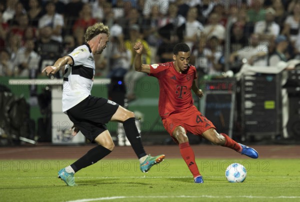 Football match, Jamal MUSIALA FC Bayern Munich right on the ball, Philipp STROMPF SSV Ulm tries to interfere with him, Donaustadion football stadium, Ulm, Germany, Europe