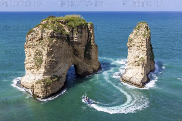 Rouche rocks in Beirut, Lebanon in the sea during daytime. Pigeon Rocks in Mediterranean sea