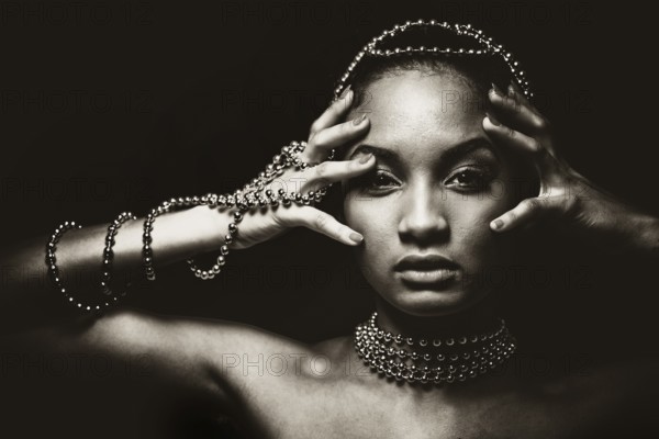 Upscale Indian woman wearing chain jewellery and beautiful makeup. Black and white photo. Mysterious beauty expressions, Toronto, Canada, North America