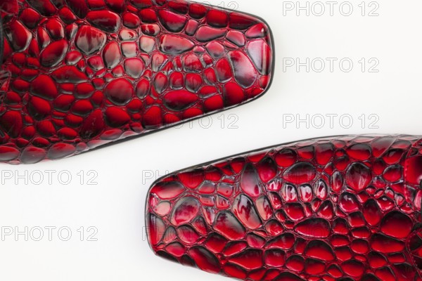 Detail of men's red shoes on white background