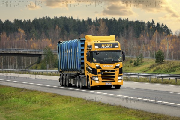 Next Generation Scania R500 truck of TransPeltola Oy hauls Bruhn Spedition cargo container on motorway in autumn. Salo, Finland. October 31, 2020