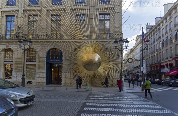 PARIS, FRANCE, DECEMBER 17, 2017: Sculpture on the facade of the building, the sun emits rays. Vendome Square, Paris, France, Europe