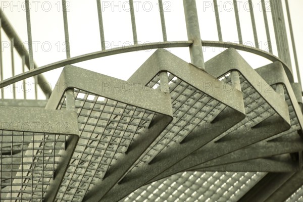 Details of a metal spiral staircase in an industrial building