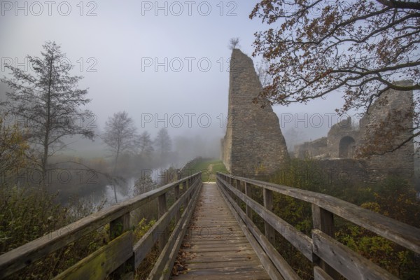 Ruins of a castle. Landscape shot in autumn. Defence system in a lake. Foggy landscape in the morning at the historical sight in Morbach, castle ruins Baldenau, Rhineland-Palatinate, Germany, Europe