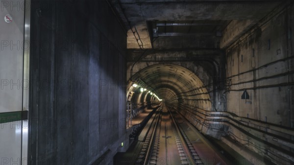 View on rails in metropolitan tube in lamps light