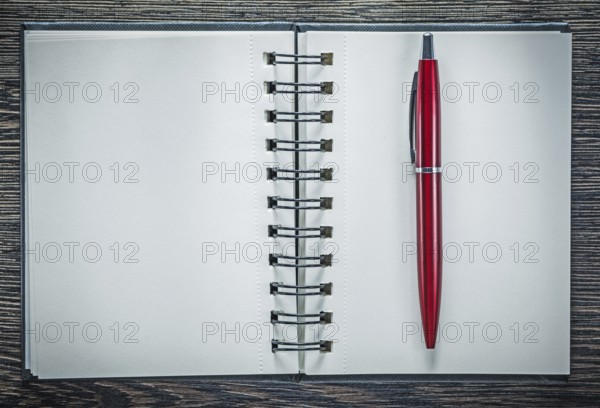 Spiral notepad ballpoint pen on vintage wooden board