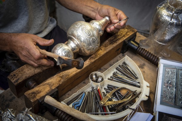 Unrecognized professional Jewellery maker working in workshop crafting silver vase. creative people handcraft handmade process