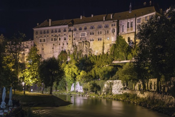 View of Cesky Krumlov castle from Vltava river at night, Czech republic