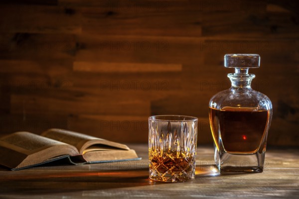 A glass of rum and an old book in a bar in Cuba