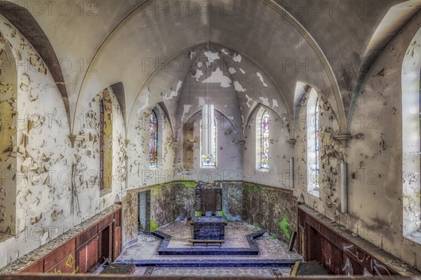 Church interior with colourfully decorated stained glass windows and an old altar, Agnus Dei, Lost Place, Plombières, Province of Liège, Belgium, Europe
