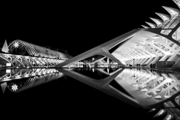 Futuristic architectural structure reflected in water at night in black and white, City of Arts and Sciences, Valencia, Spain, Europe