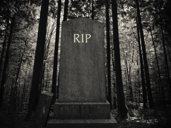 Spooky RIP Gravestone In A Dark Forest Setting