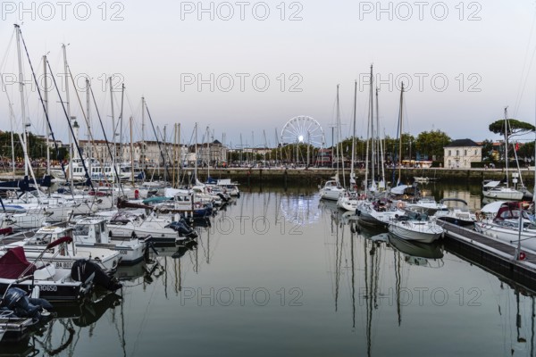 La Rochelle, France, August 6, 2018: The old port. Enclosed by its medieval towers, the picturesque harbour is now lined with seafood restaurants and bars, Europe