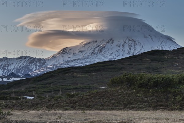 Beautiful clouds over the volcano at sunset. Active Ichinsky Volcano, Kamchatka Peninsula, Far East, Russia, Eurasia, Europe