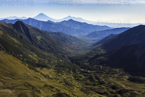 Beautiful autumn mountain landscape: scenery view of mountains, lake and volcanoes. Eurasia, Russian Far East, Kamchatka Peninsula