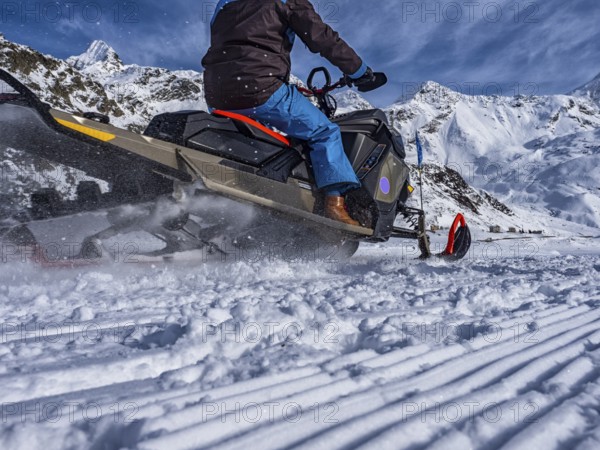 Snowmobile on a trail in the Italian alps